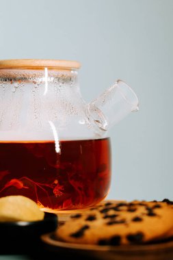Enjoying hot tea with freshly baked cookies and lemon slices on a cozy afternoon
