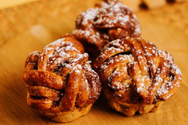 Freshly baked cinnamon rolls in a cozy kitchen setting during afternoon hours