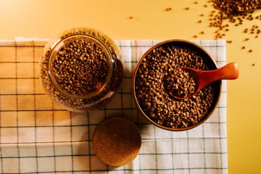 Karabuğday filizleri bir kasede ve kavanozda yumuşak ışıklandırmalı bir masada sergilenir