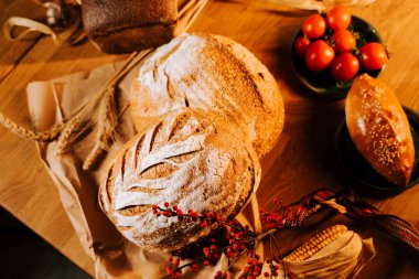Köy ahşap bir masada kiraz domatesli taze pişmiş zanaatkar ekmeği.