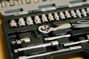 Tool set with various sockets and a ratchet positioned inside a carrying case