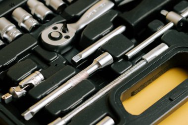 Set of various tools arranged neatly in a black storage case