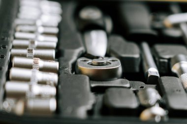 Tool kit with various tools and sockets arranged neatly on a black tray