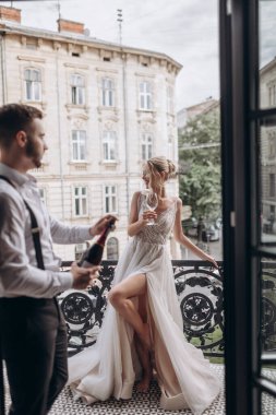 Couple celebrating a special moment on a balcony in the city during the daytime