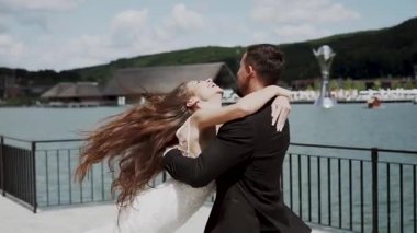 Bir düğünde, deniz kenarında dans eden çift manzaralı bir yerde.