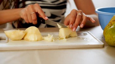 Lezzetli bir aperatif ya da tatlı için mutfakta armut dilimlemek.