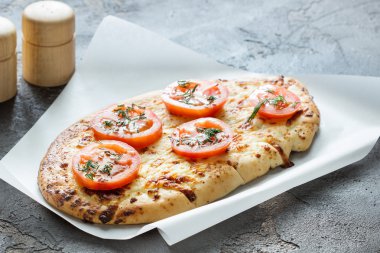Peynir ve domates, otlar baharat beton backg üzerinde pizza