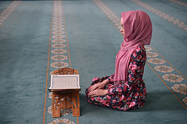 Young Muslim reads the Koran, sitting in the direction of the Qibla, hands on knees, ending prayer, witness, prayer Rukn