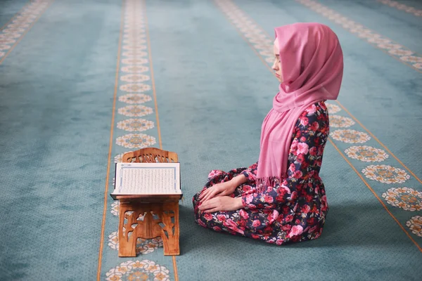 Young Muslim reads the Koran, sitting in the direction of the Qibla, hands on knees, ending prayer, witness, prayer Rukn