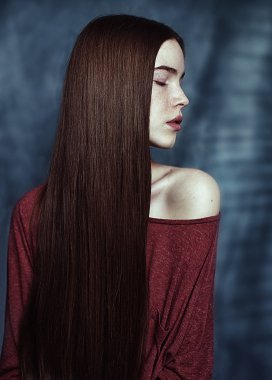 Girl's close portrait in profile with long hair in red sweater clipart