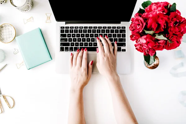 Workplace with laptop, girl's hands
