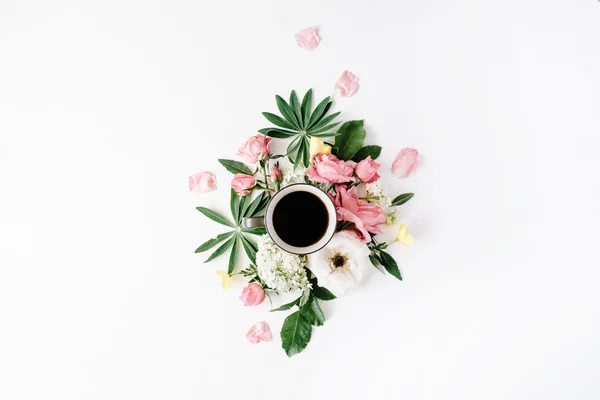 Black coffee mug among flowers