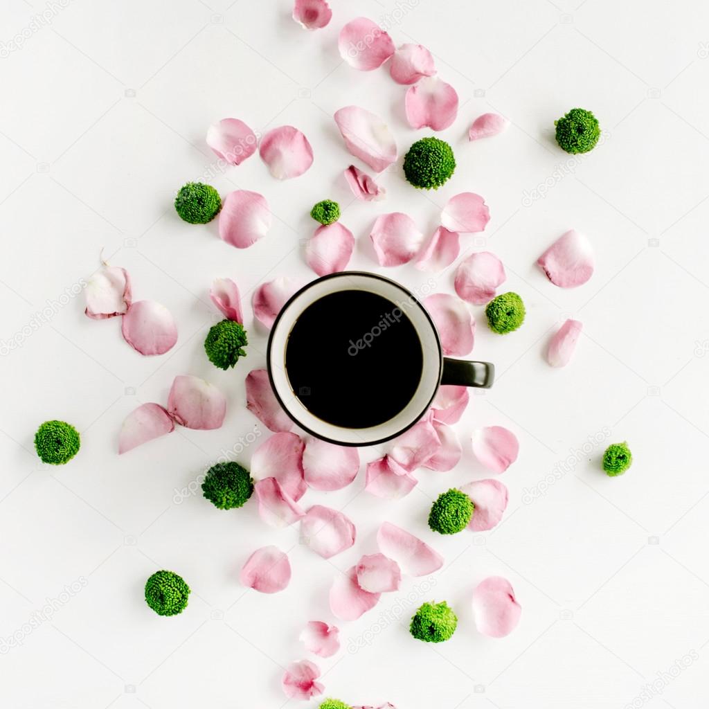 Coffee cup in rose petals