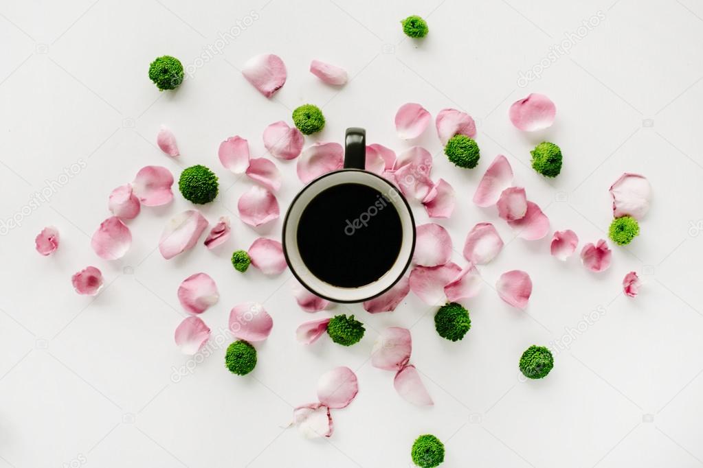 Coffee cup in rose petals