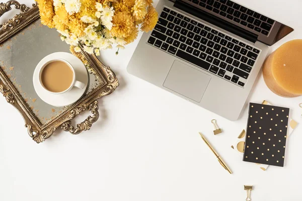 Home office desk workspace with laptop, coffee cup, vintage tray, fall wildflowers bouquet on white background. Flat lay, top view girl boss work business concept for lifestyle blog, social media.