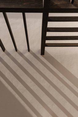 Bej duvarları ve duvarlarında güneş ışığı gölgeleri olan modern doğu tarzı bir bina. Estetik asgari mimari ön cephe tasarım kavramı arka planı