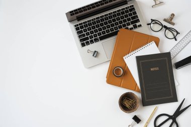 Laptop bilgisayar, tablet ped, beyaz masa arkaplanındaki notlar. Düzlük, üst görünüm estetik minimal serbest yazar, blog yazarı ofis çalışma alanı