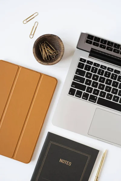 Aesthetic minimalist home office desk workspace on white background. Notebook, laptop computer, tablet pad. Business, work concept for blog, website, social media.