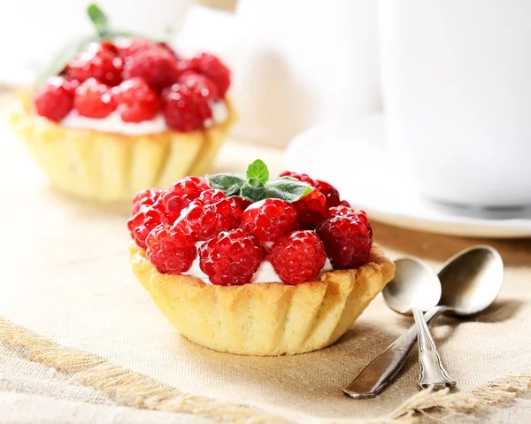 Tasty cakes with raspberries