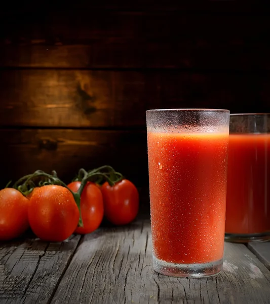 Glasses of tomato juice on table