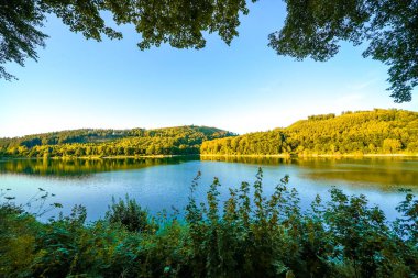 Sauerland 'deki Hennesee manzarası ve çevreleyen yeşil manzara. Kuzey Ren-Vestfalya 'da Meschede yakınlarında göl kenarında bir baraj..