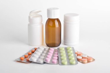 Medical bottles and pills isolated on white background. Concept of medical treatment supplies.