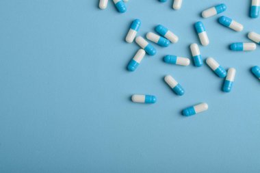 Mavi arkaplan üzerinde ilaç kapsülleri, kopya alanı ile üst görünüm