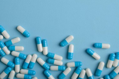 Mavi arkaplan üzerinde ilaç kapsülleri, kopya alanı ile üst görünüm