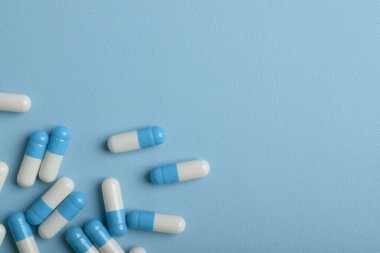 Mavi arkaplan üzerinde ilaç kapsülleri, kopya alanı ile üst görünüm