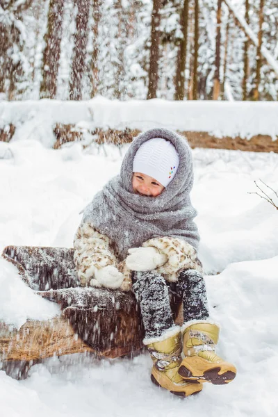 Winter portrait of cute smiling child girl on the walk in sunny snowy forest — Stock Photo, Image