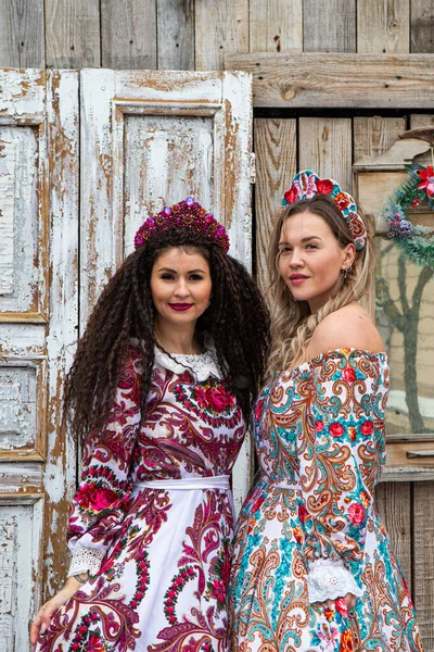 Russian girl in Russian national costumesof winter in a village