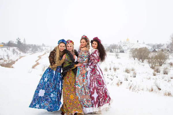 Russian girl in Russian national costumesof winter in a village