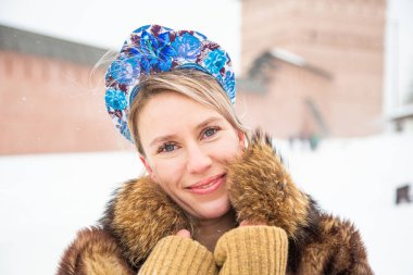 Güzel Rus kızı, ulusal bir kış elbisesi içinde.