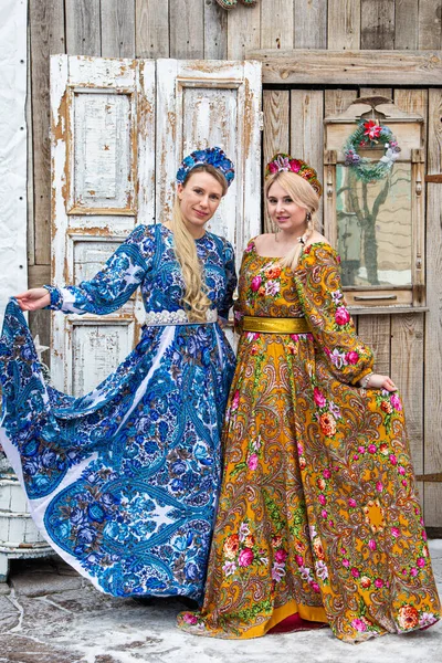 Russian girl in Russian national costumesof winter in a village