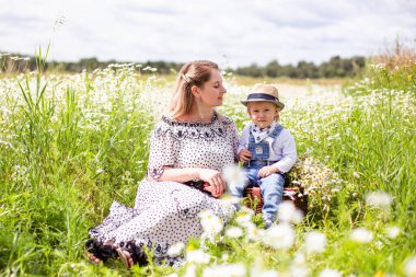 Genç anne ve küçük tatlı oğlu bir tarlada yürüyorlar.