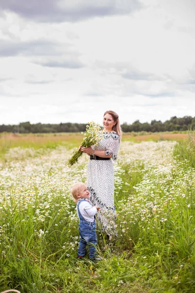 Genç anne ve küçük tatlı oğlu bir tarlada yürüyorlar.
