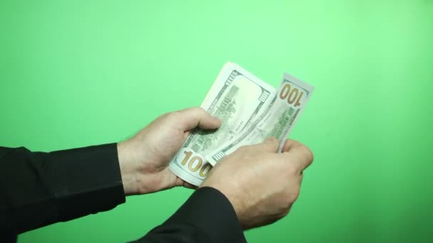 Green background, hands consider dollars — Stock Video