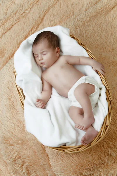 Bebê recém-nascido adormecido deitado em cesta de vime — Fotografia de Stock
