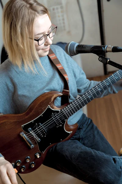 Jonge vrouw spelen gitaar en zang microfoon — Stockfoto