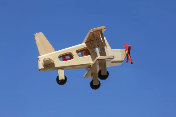 Holzflugzeug fliegt mit blauem Himmel - Seitenansicht — Stockfoto