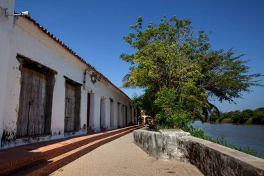 Magdalena River and the beautiful colonial streets of the Heritage Town of Santa Cruz de Mompox in Colombia.