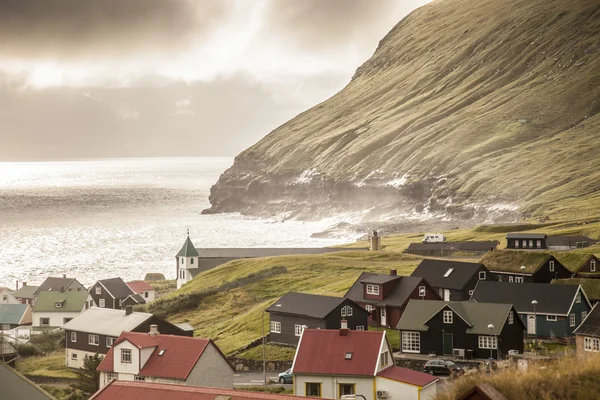 Danimarka, Faeroe adanın Gjogv Köyü günbatımı ve bulutlu.