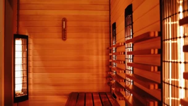 Sauna interior, conceito de relaxamento e reabastecimento de saúde. Sauna finlandesa. Sauna infravermelha. Câmera mover da direita para a esquerda. — Vídeo de Stock