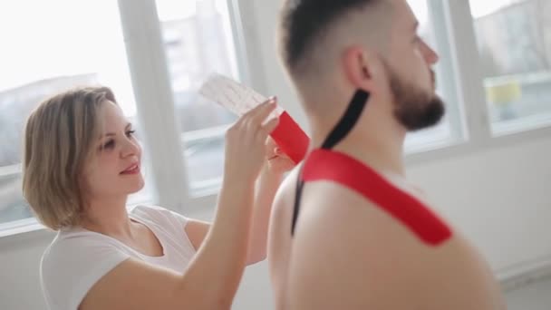 Hastaların Boynuna Omuzlarına Kinezyoloji Bandı Yapıştıran Bir Terapist Kinesioting Spor — Stok video