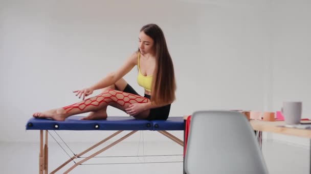 Female Athlete Physio Tape Her Leg Kinesiology Physical Therapy — Stockvideo