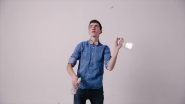 Beyaz arka planda şişe hokkabazlığı yapan erkek barmen. Barmen Show, adam profesyonel barmen..