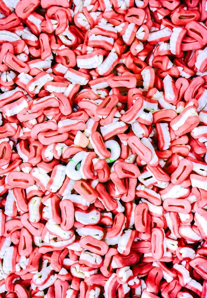 Tatlı kırmızı ve beyaz şeker dişleri arka plan olarak — Stok fotoğraf