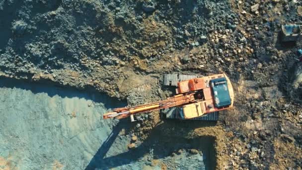 Aerial view on top Excavator that digs and levels the pit for the house. Heavy machinery digs a pit and levels the horizon. Building a house. — Stock Video