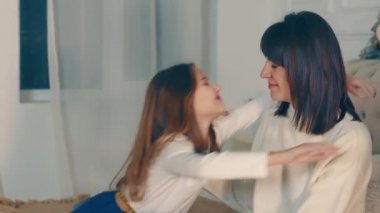 Mutlu anne bebeğine sarılıyor. Aile mutluluğu. Kızına karşı duygular besleyen bir annenin duyguları. Anneler çocuğu sever. Ailede samimiyet var. Duyguların ahengi. Mutlu anne.