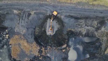 Hava manzaralı Kazıcı kamyonu siyah toprakla dolduruyor. Çernozem kamyona yükleniyor.